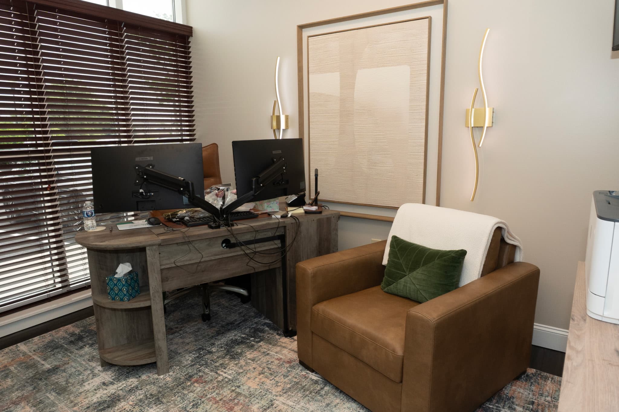 A Loving Creations interior — designed office with warm wood, leather, and brass sconces